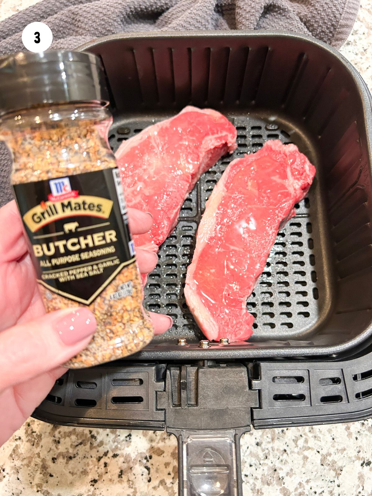Bottle of Grill Mates steak seasoning and steaks.