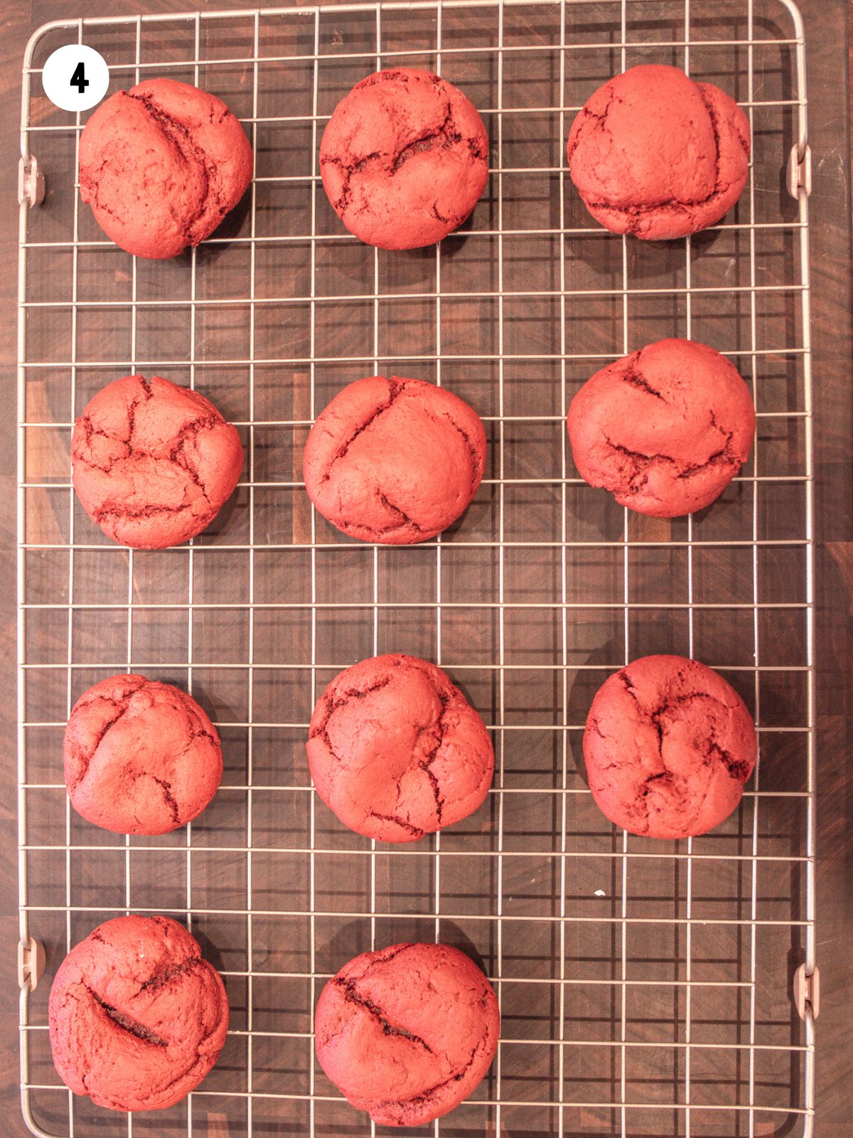 Baked red velvet cake mix cookies on a wire cooling rack.