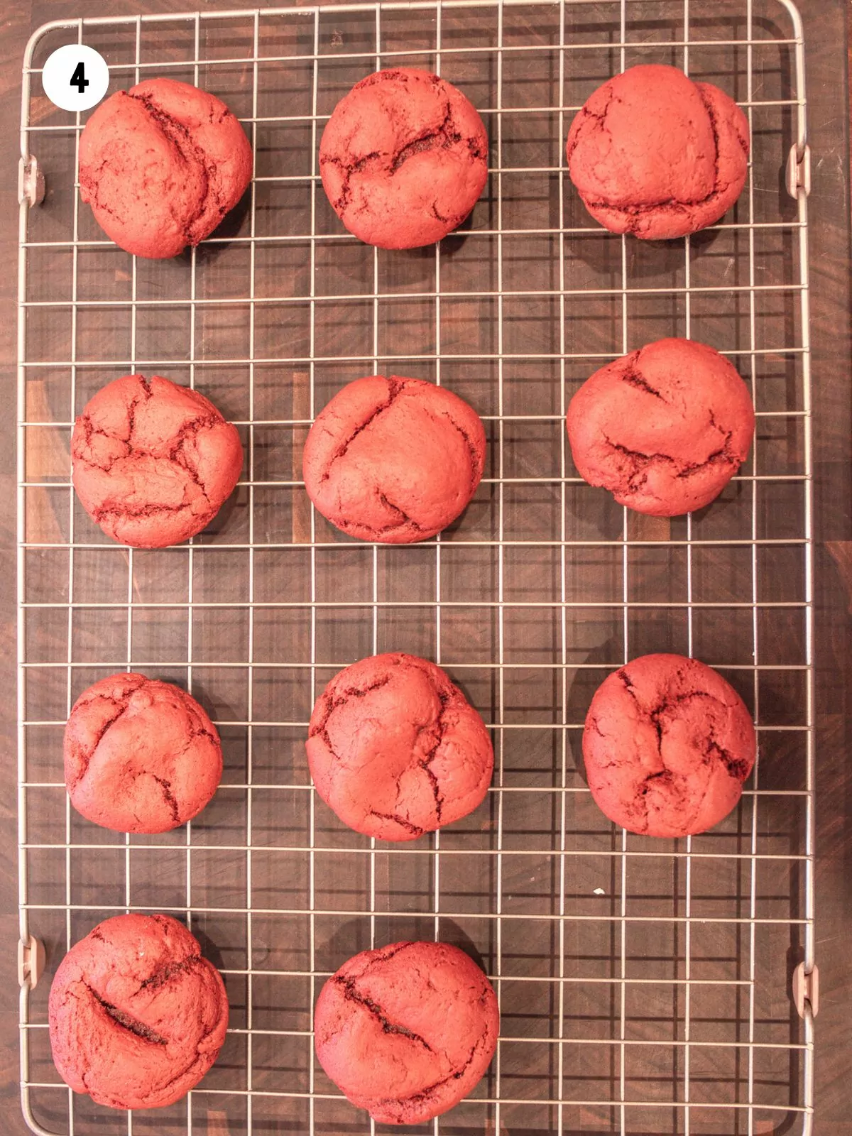 Baked red velvet cake mix cookies on a wire cooling rack.