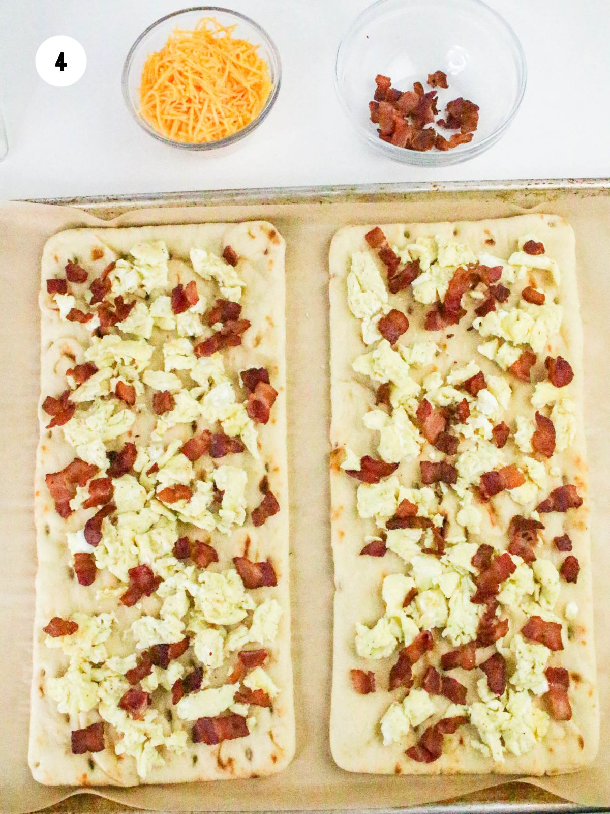 Cooked crumbled bacon added on top of the eggs.