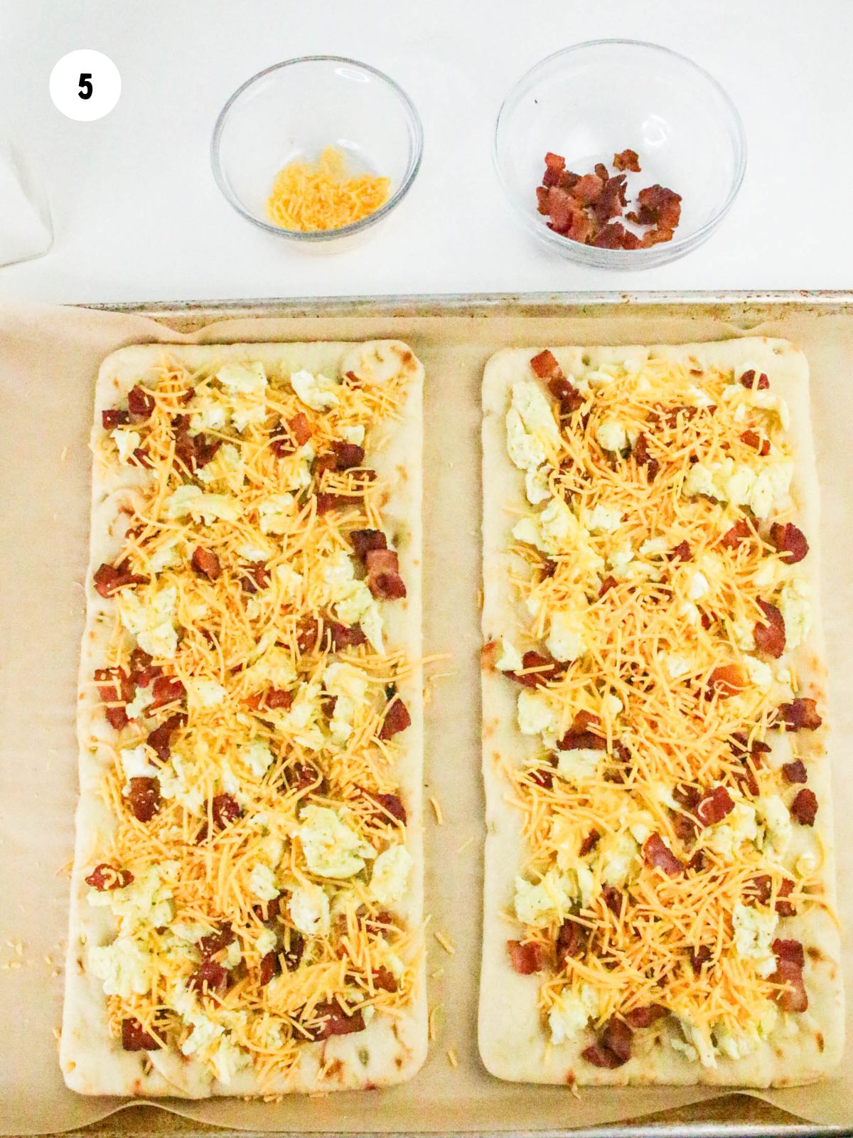Shredded cheddar cheese added to the eggs and bacon.