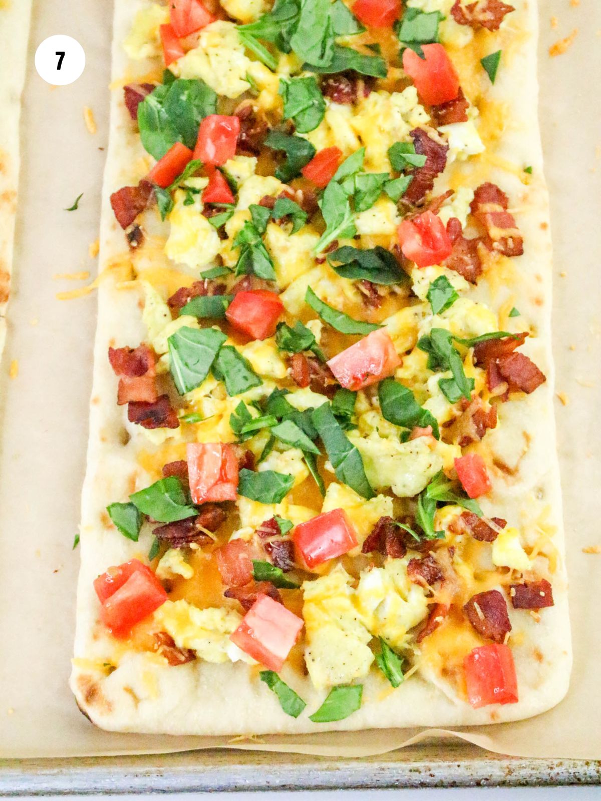 A flatbread topped with fresh tomatoes and spinach.
