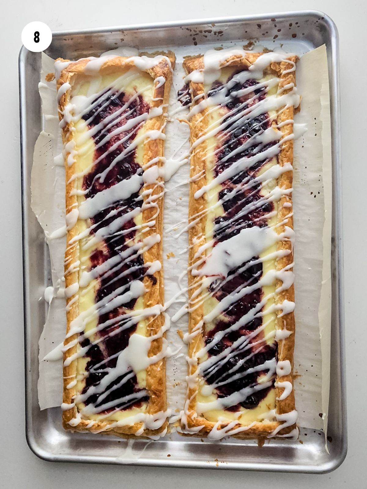 Icing drizzled on top of the baked blueberry danish.