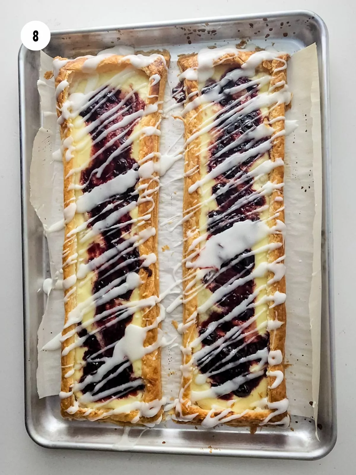 Icing drizzled on top of the baked blueberry danish.