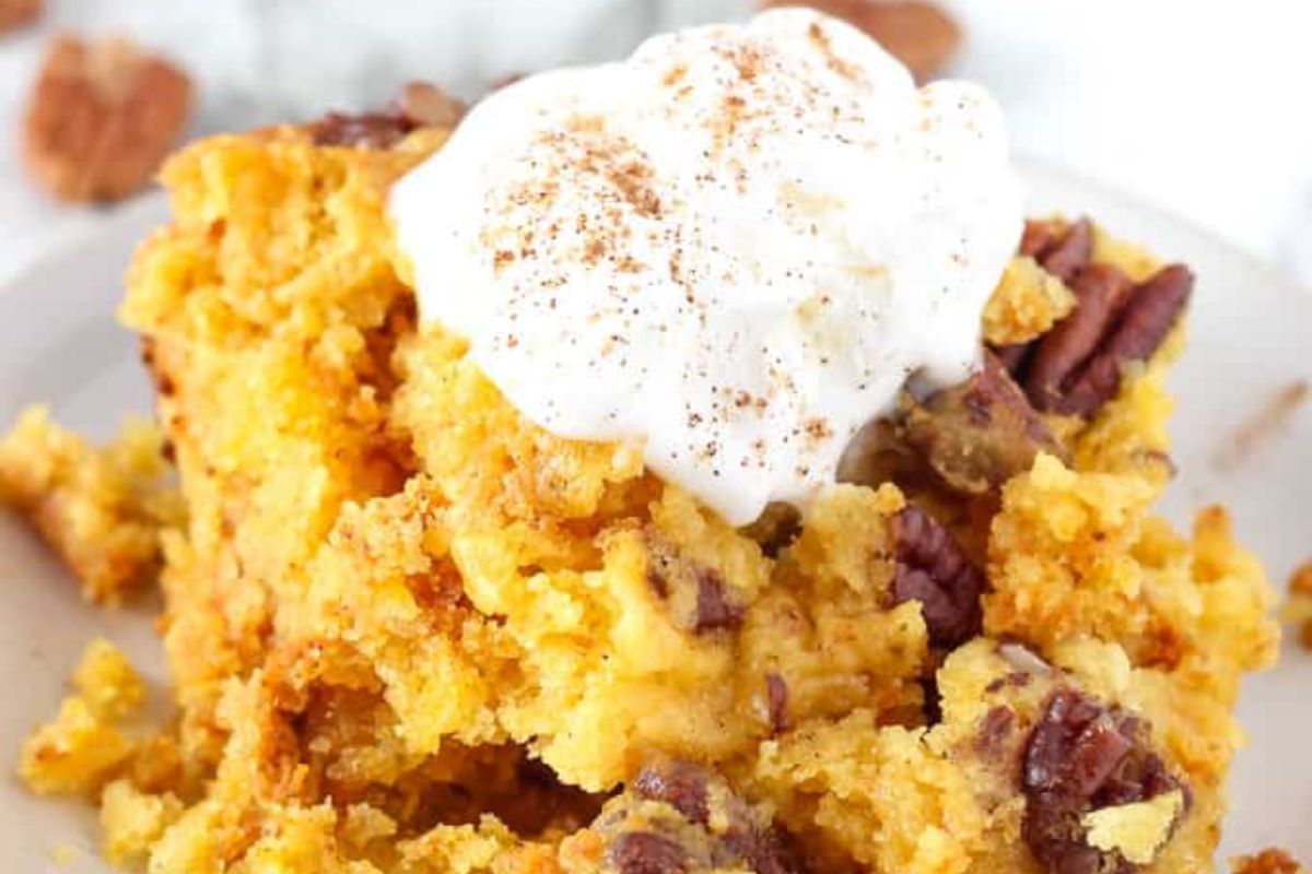 bowl of Crockpot Pumpkin Dump Cake with ice cream on top