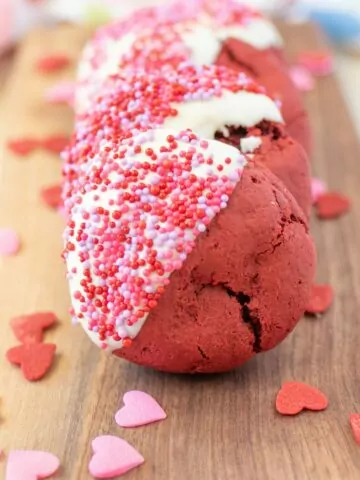 Red velvet cookies dipped in white chocolate and sprinkles.