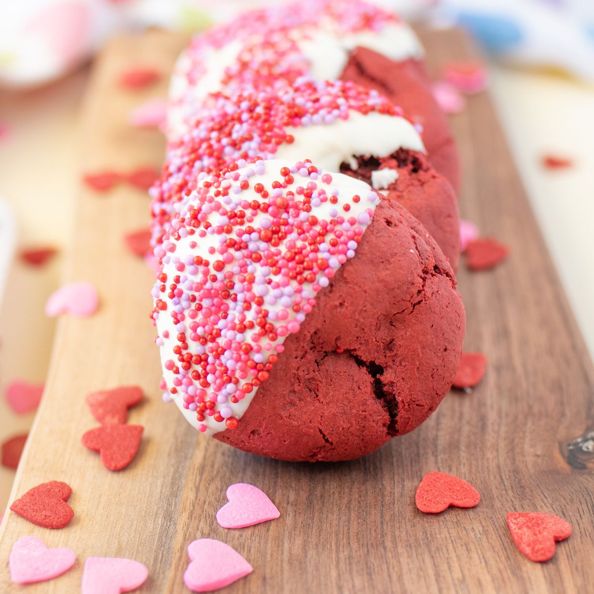 Red velvet cookies dipped in white chocolate and sprinkles.