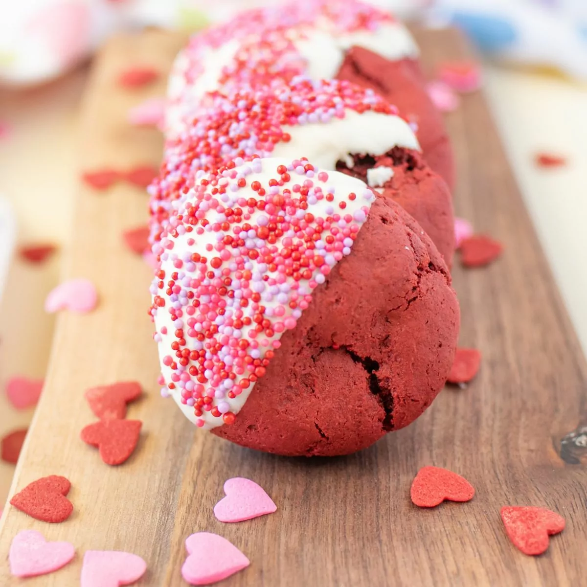 Red velvet cookies dipped in white chocolate and sprinkles.