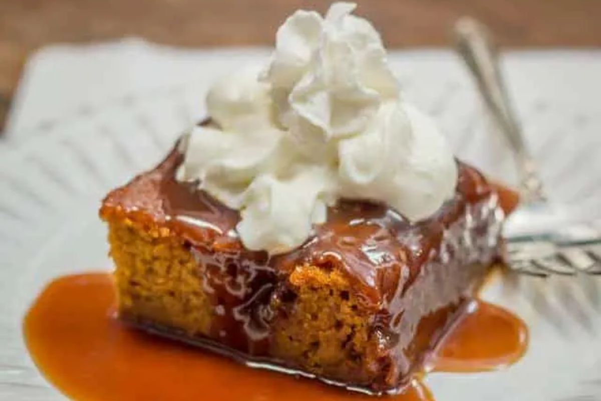piece of Sticky Toffee Pumpkin Pudding topped with whipped cream