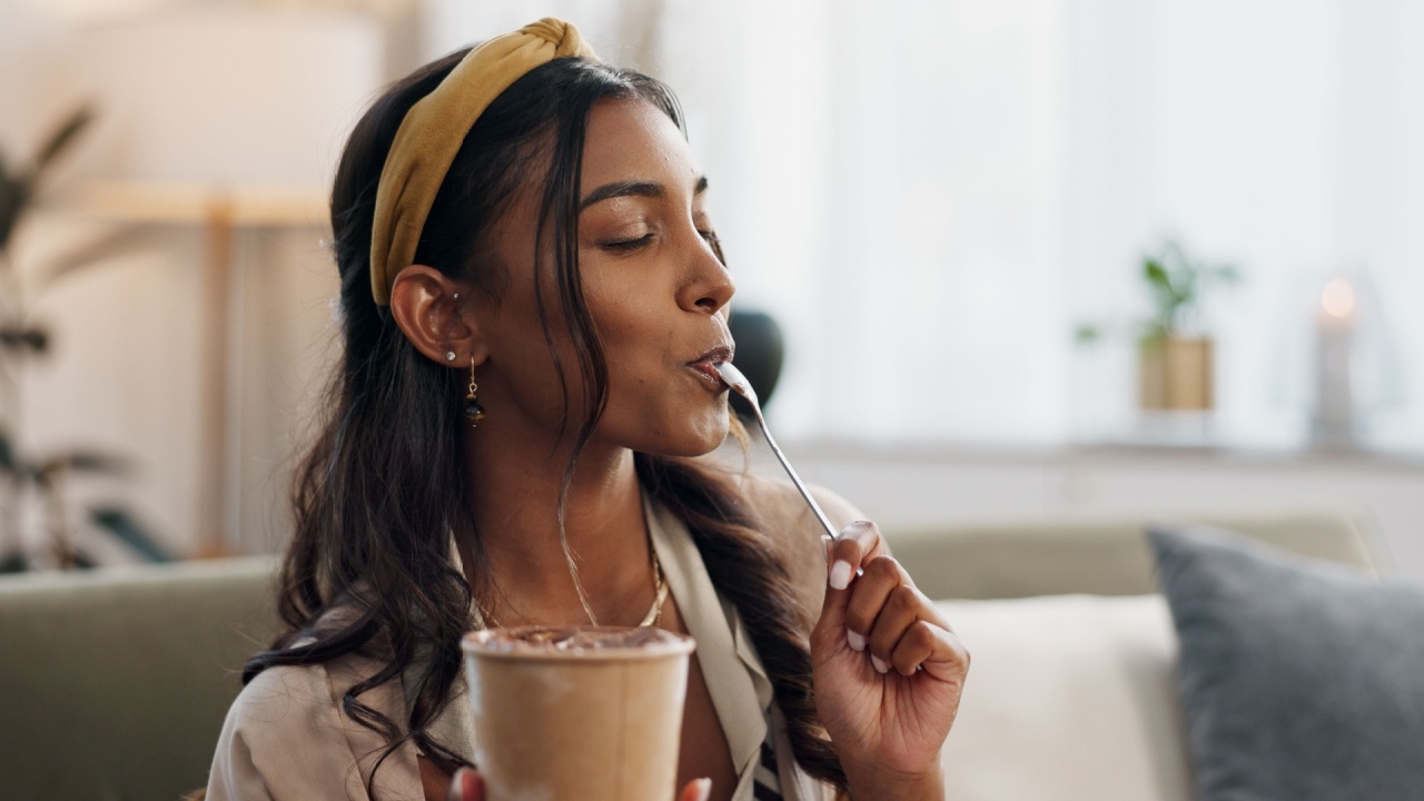 Woman, eating ice cream and sofa in house.jpg