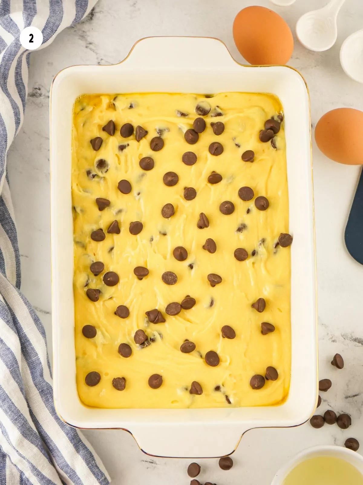 batter for bar cookies with chocolate chips sprinkled on top in 9x12 baking pan.