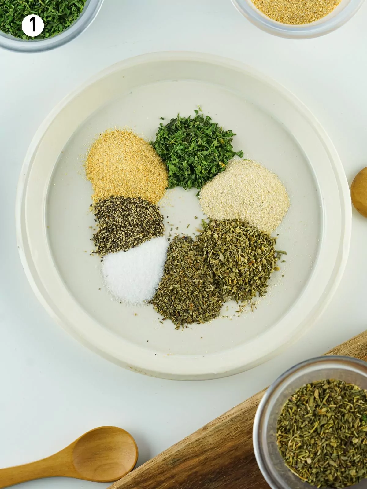 dried herbs, salt and pepper in small plate.