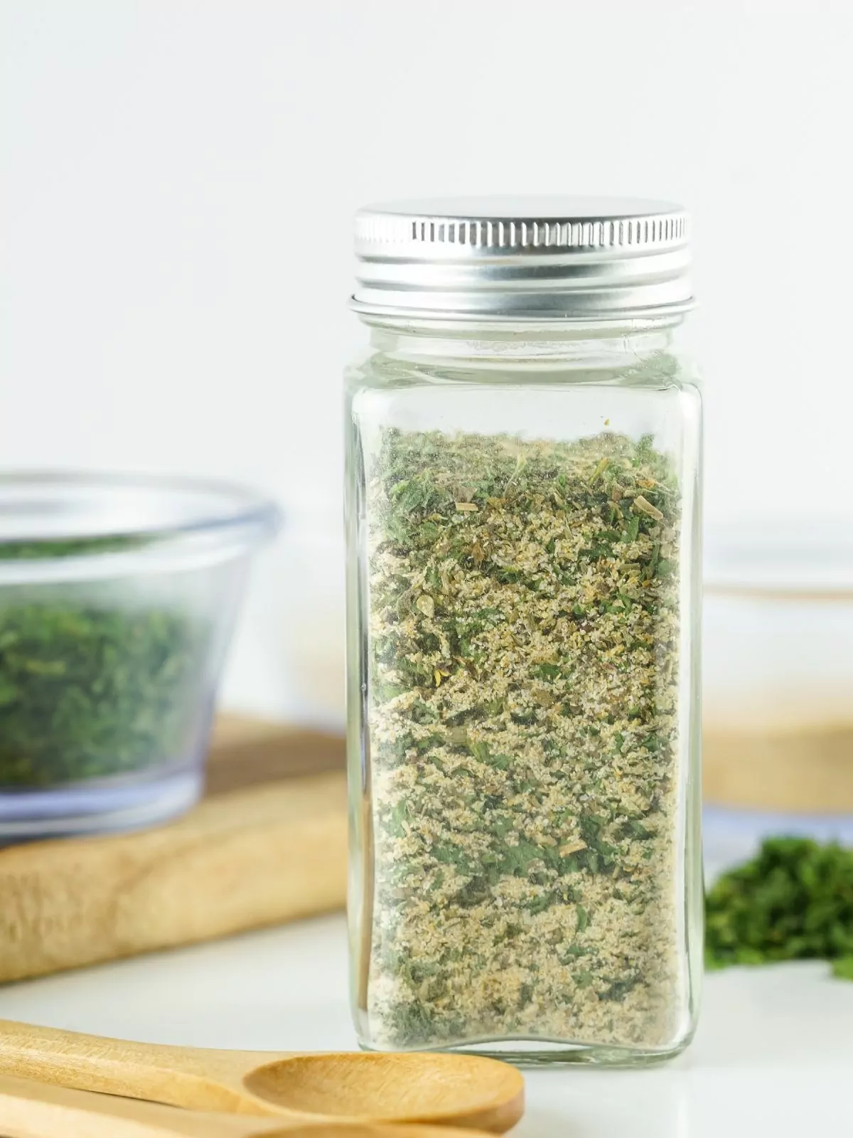 glass bottle standing up with dried spaghetti sauce seasoning mix.