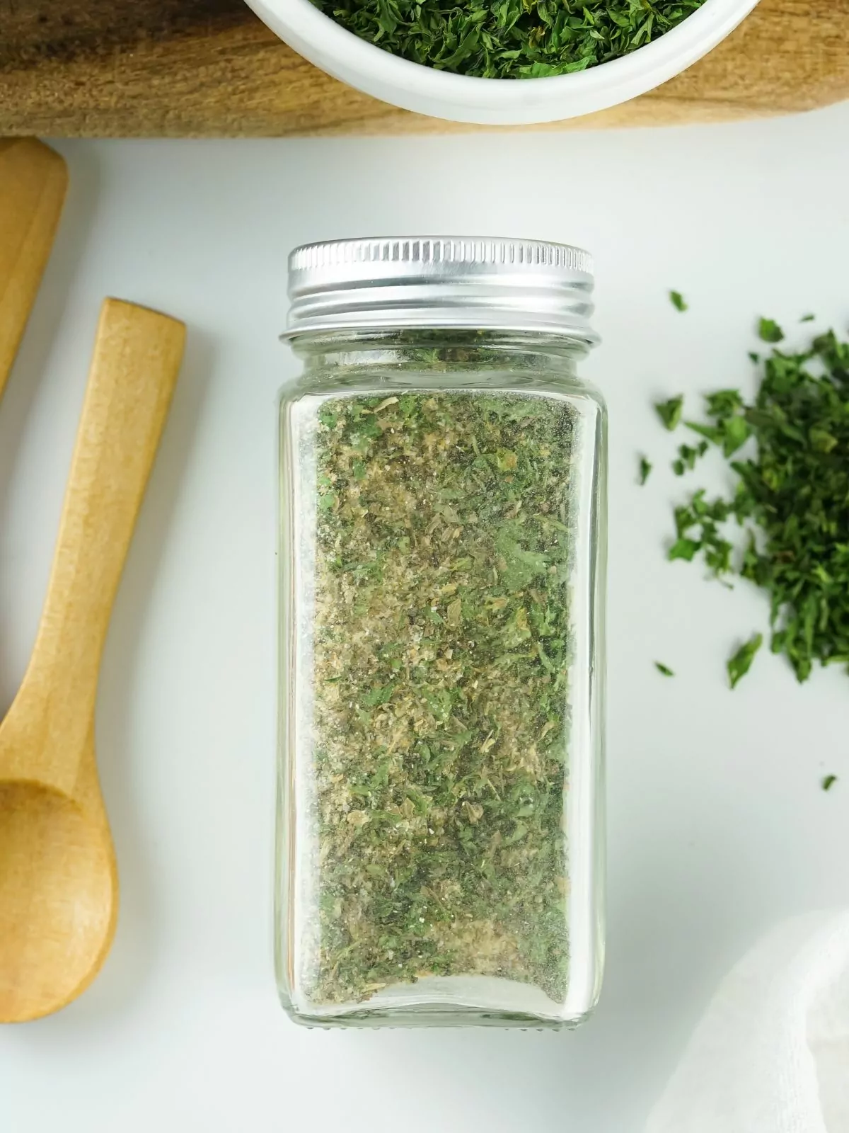 glass spice bottle with homemade spaghetti seasoning mix.