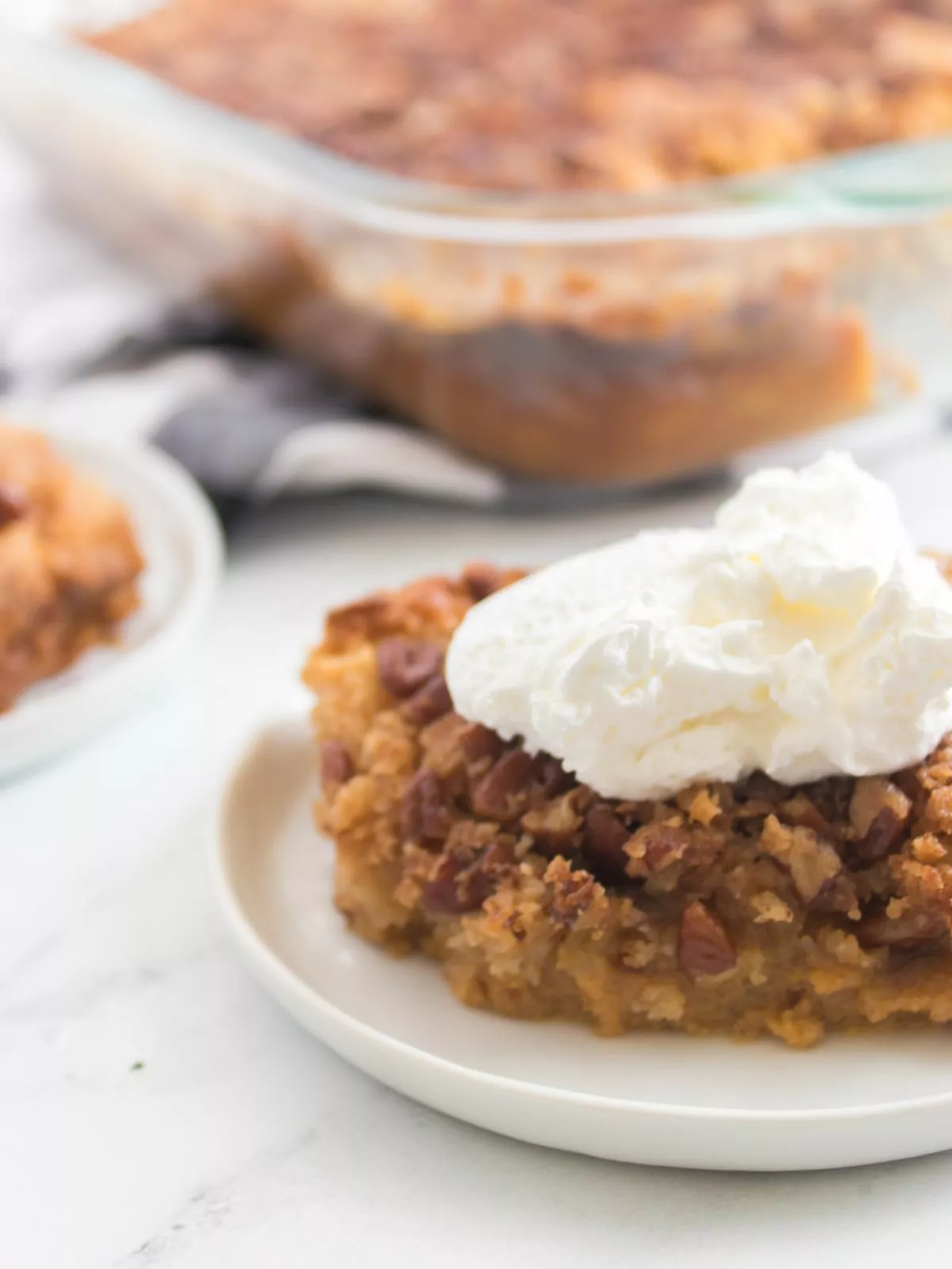 closeup of pumpkin crunch cake recipe with whipped cream.