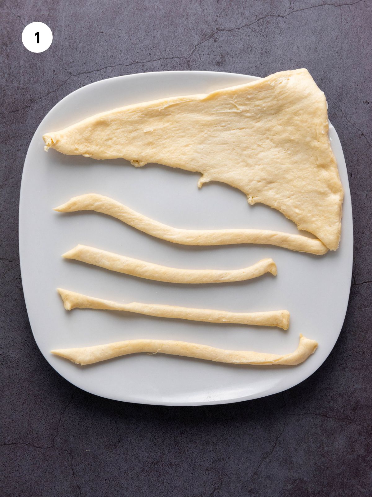 Plate with a crescent dough triangle and crescent dough strips.