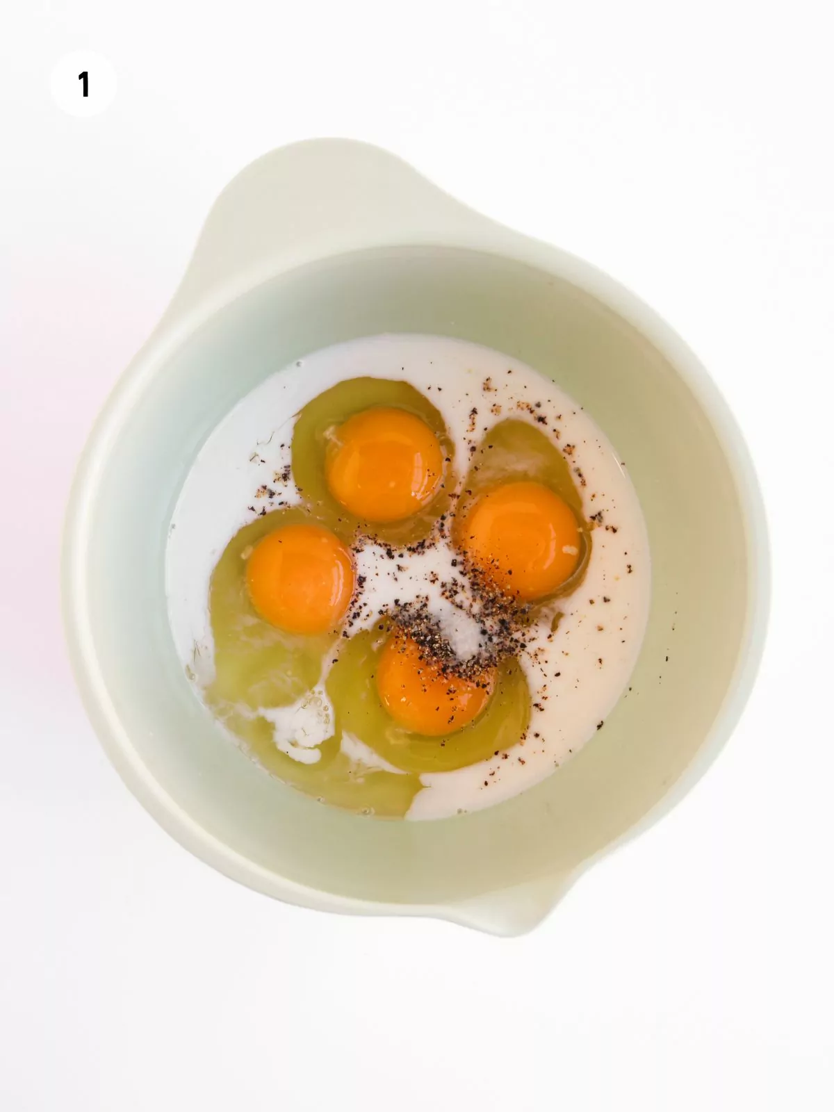 eggs, milk, seasoning in bowl.