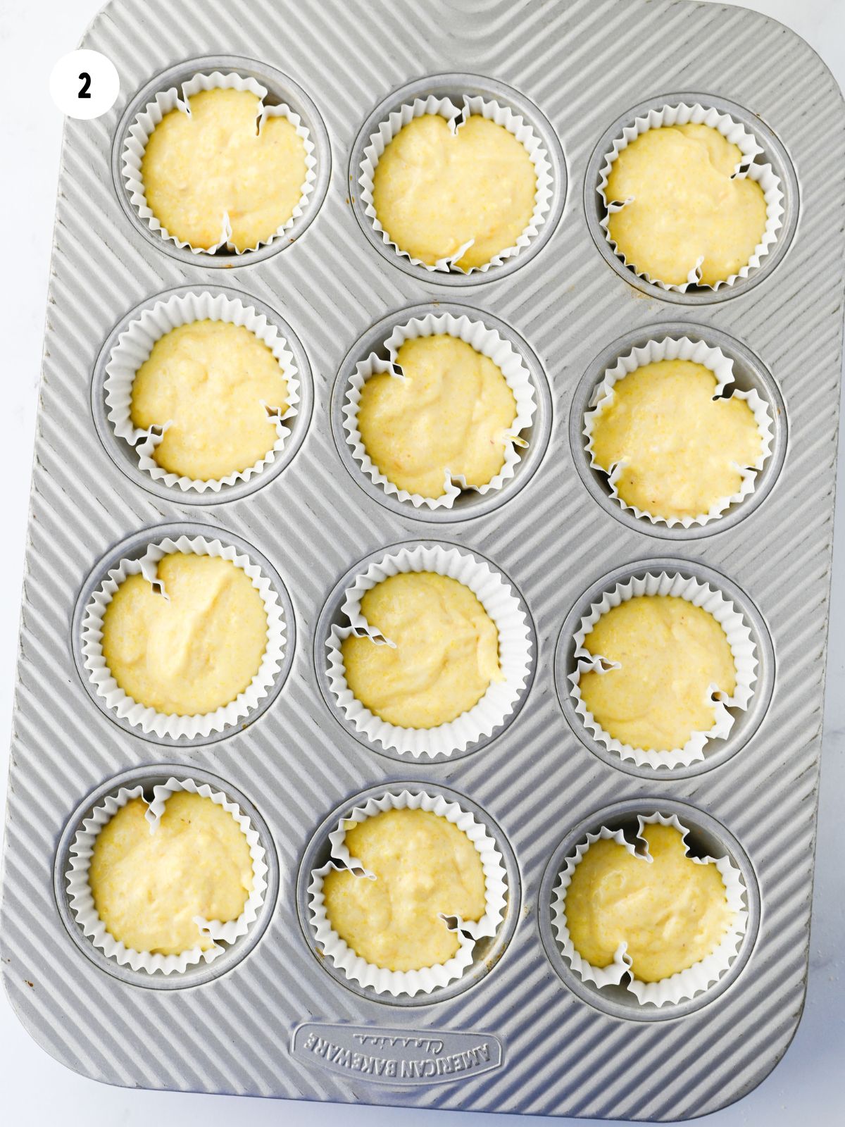 Batter divided into the muffin tin.