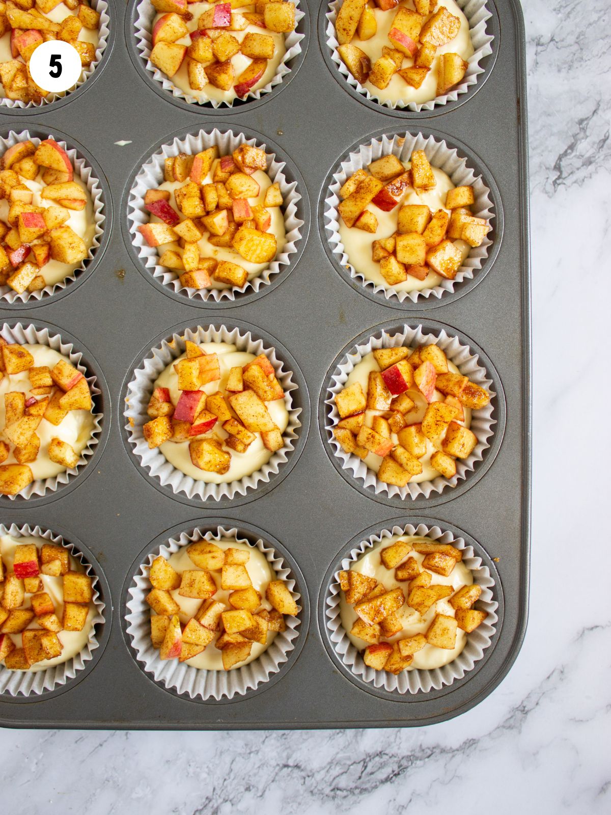 Apple topping added on the cream cheese filling.