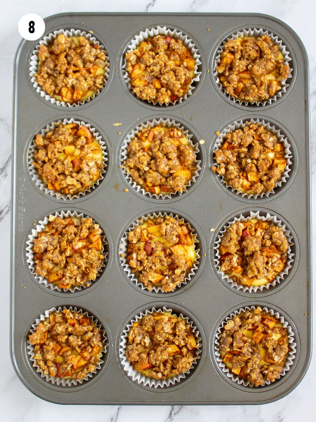 Baked mini cheesecakes in a muffin tin.