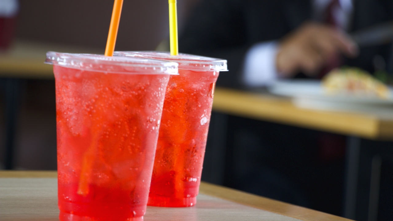 Berries Italian soda is on wooden table.