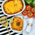 Baked Chicken Taquitos in a casserole dish and served on a plate.