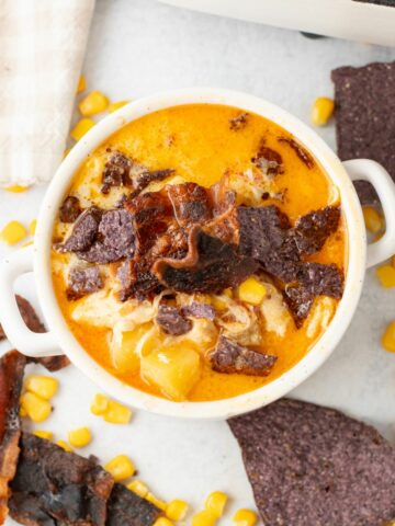 Chicken Corn Chowder topped with bacon and tortilla chips.