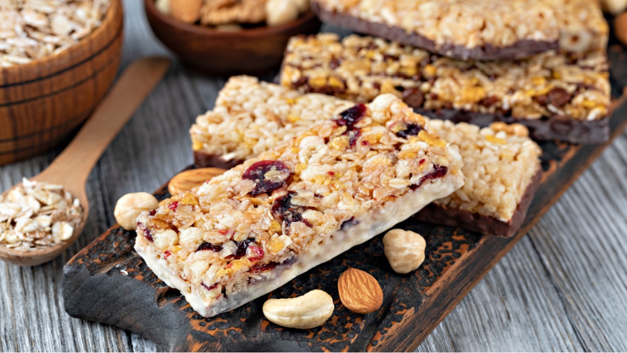 Granola bars with nuts and dried fruits on wooden background