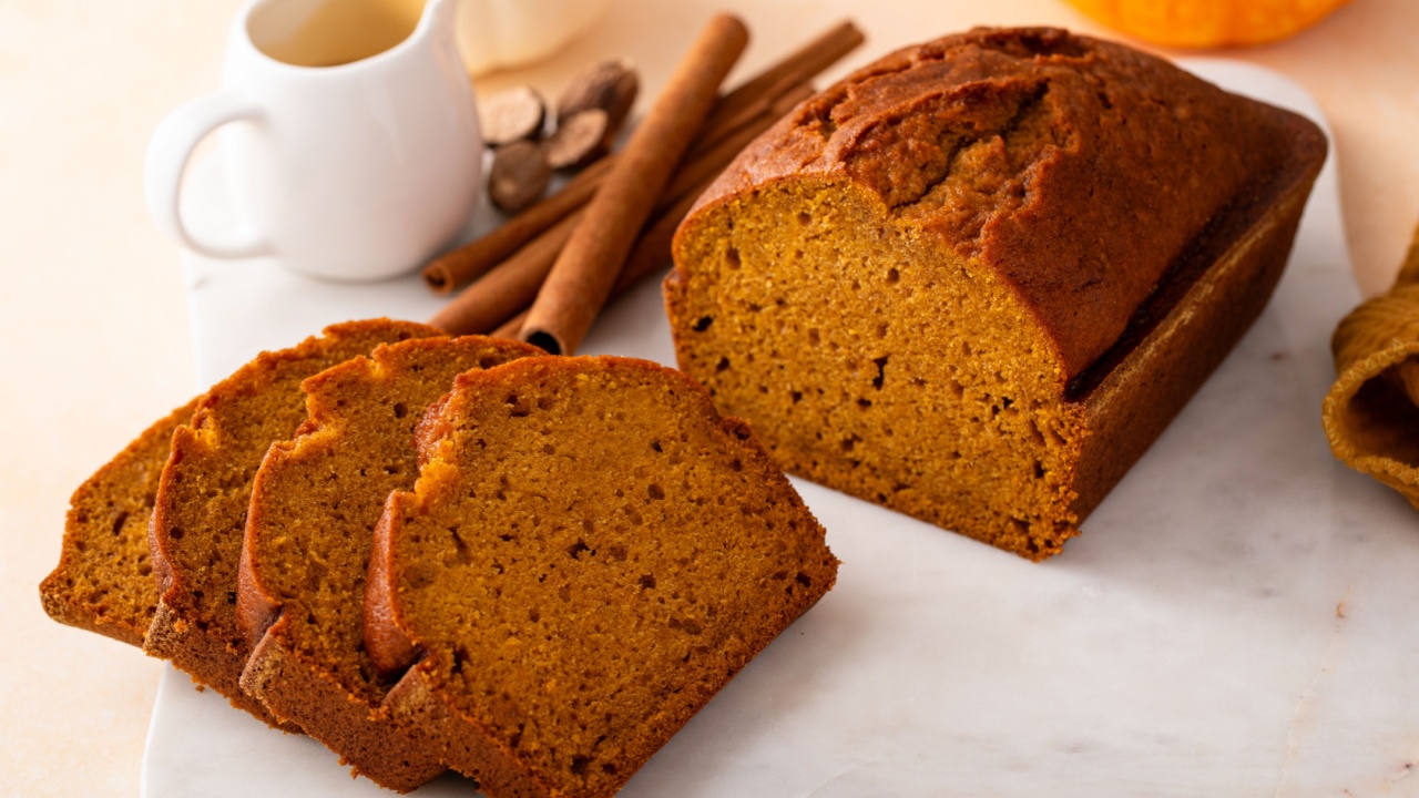 Pumpkin bread freshly baked sliced on a serving board, Thanksgiving dessert idea