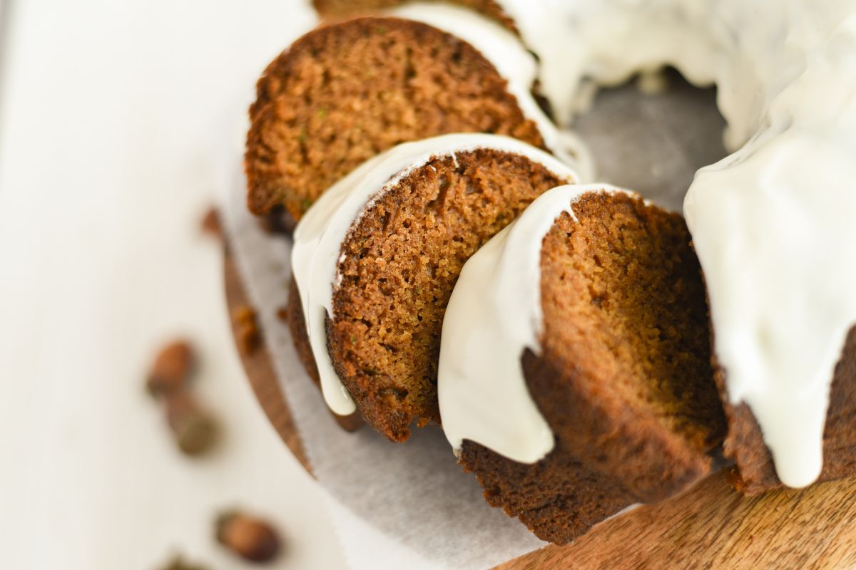 Sliced Zucchini Pumpkin Bread with cream cheese frosting.