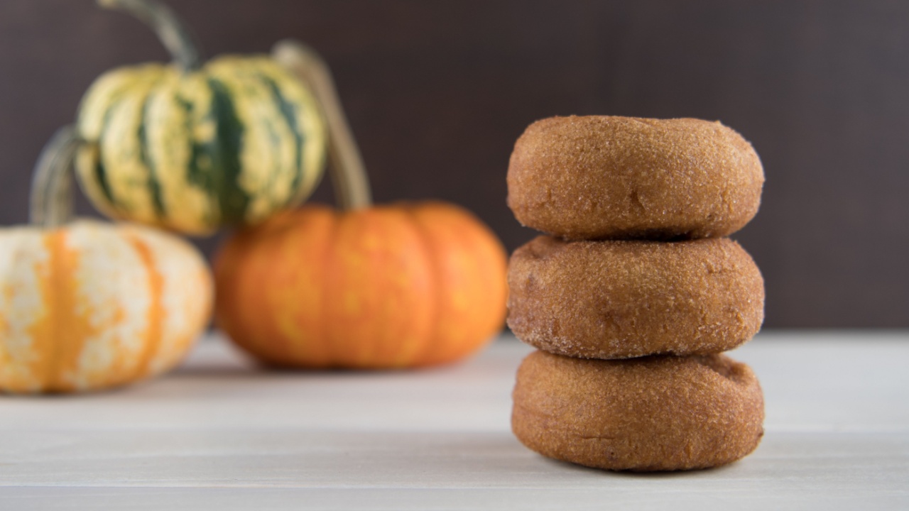 Three Pumpkin Spice Donuts on Light Background