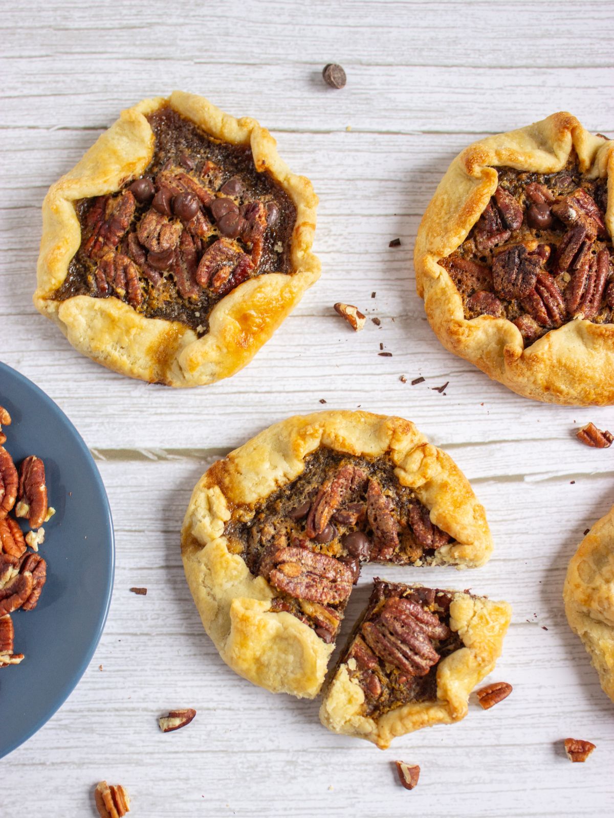 Mini Chocolate Pecan Galettes with the one at the bottom with a slice cut.
