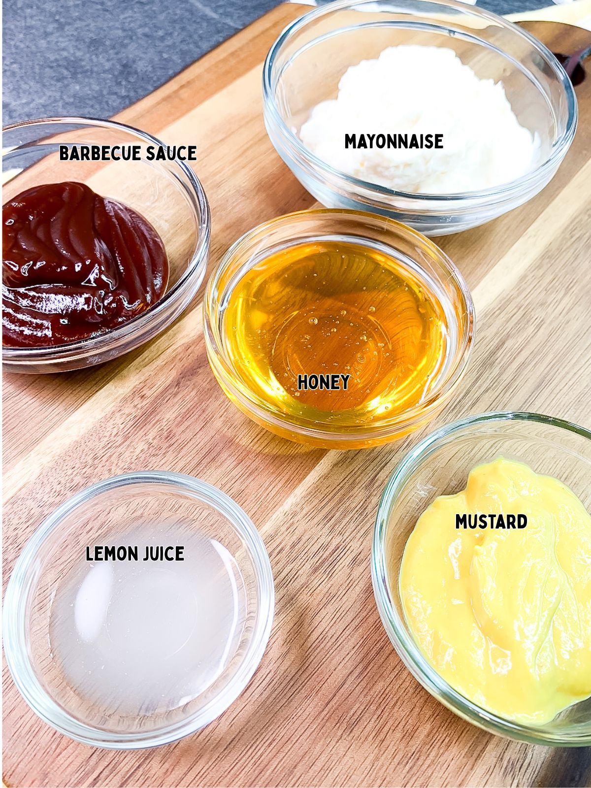 5 ingredients for dipping sauce in small clear glass bowls.