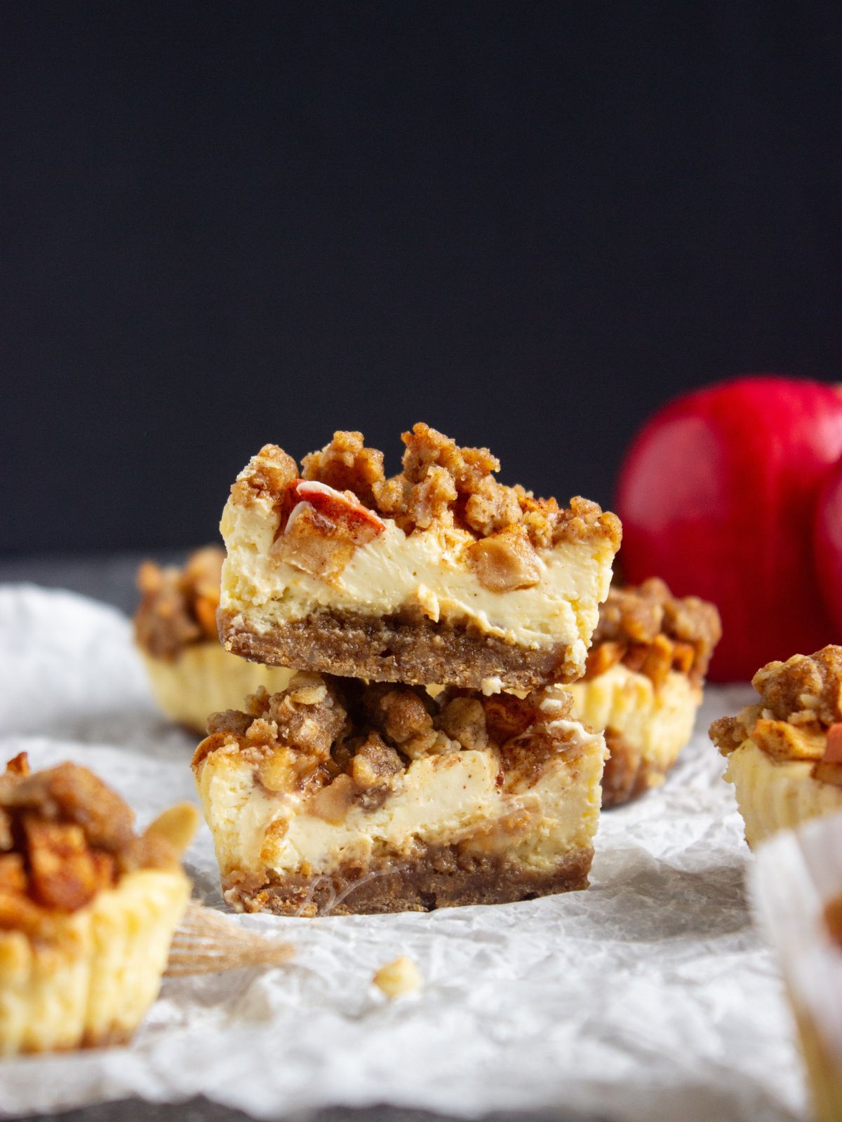 Cut apple cheesecake cupcake with the halves stacked on each other.