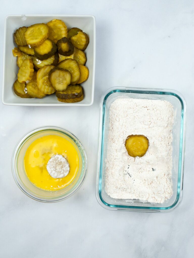 dipping pickles in flour and in beaten eggs.