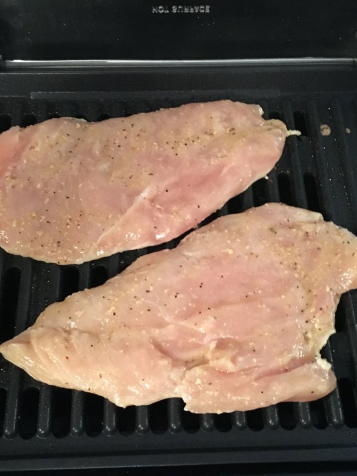 raw chicken on grilled seasoned with Italian dressing.