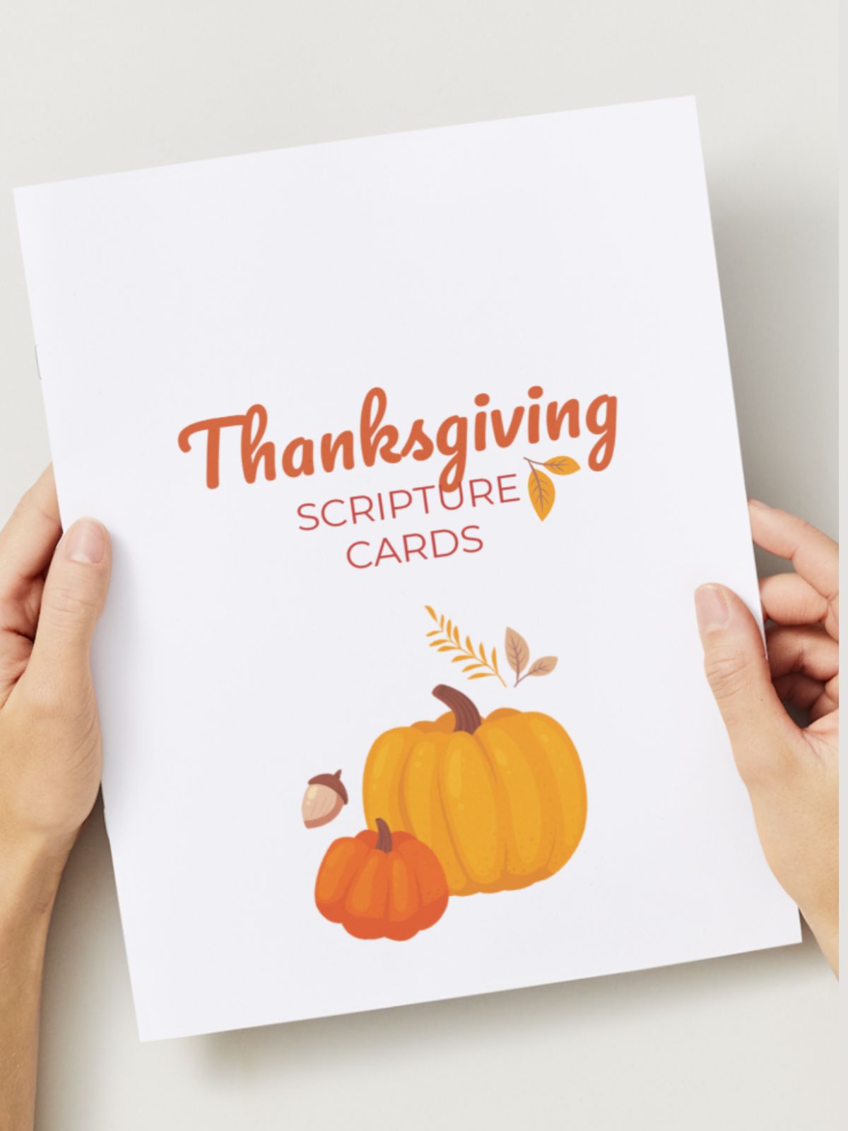 two hands holding thanksgiving greeting card verses.