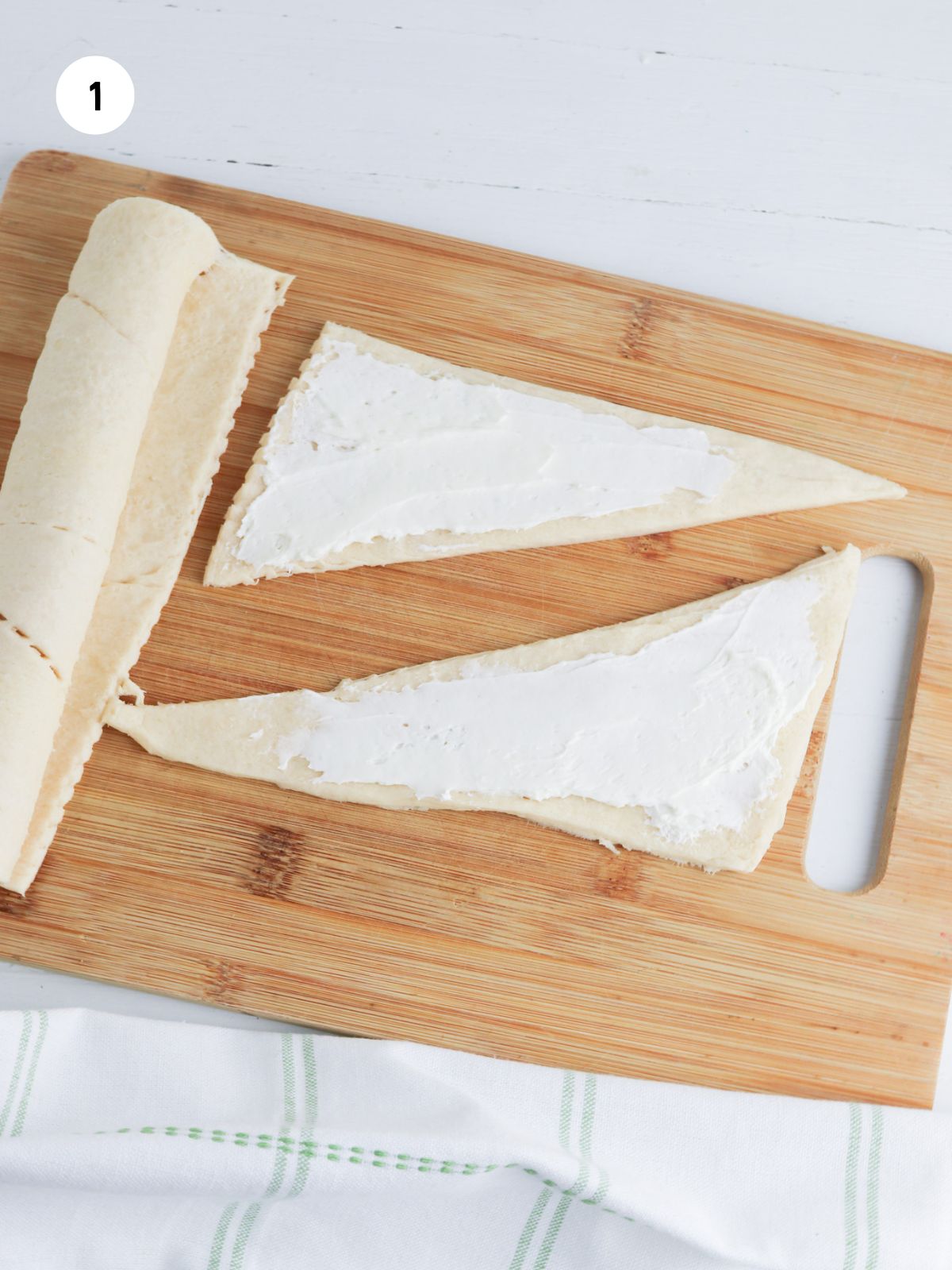 cream cheese spread on crescent triangles.