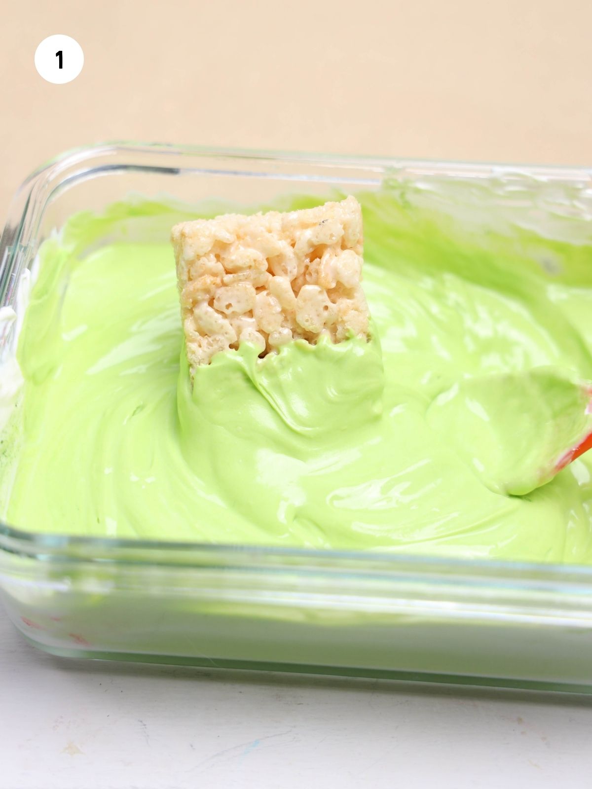 dip rice krispie treat in melted green white chocolate.