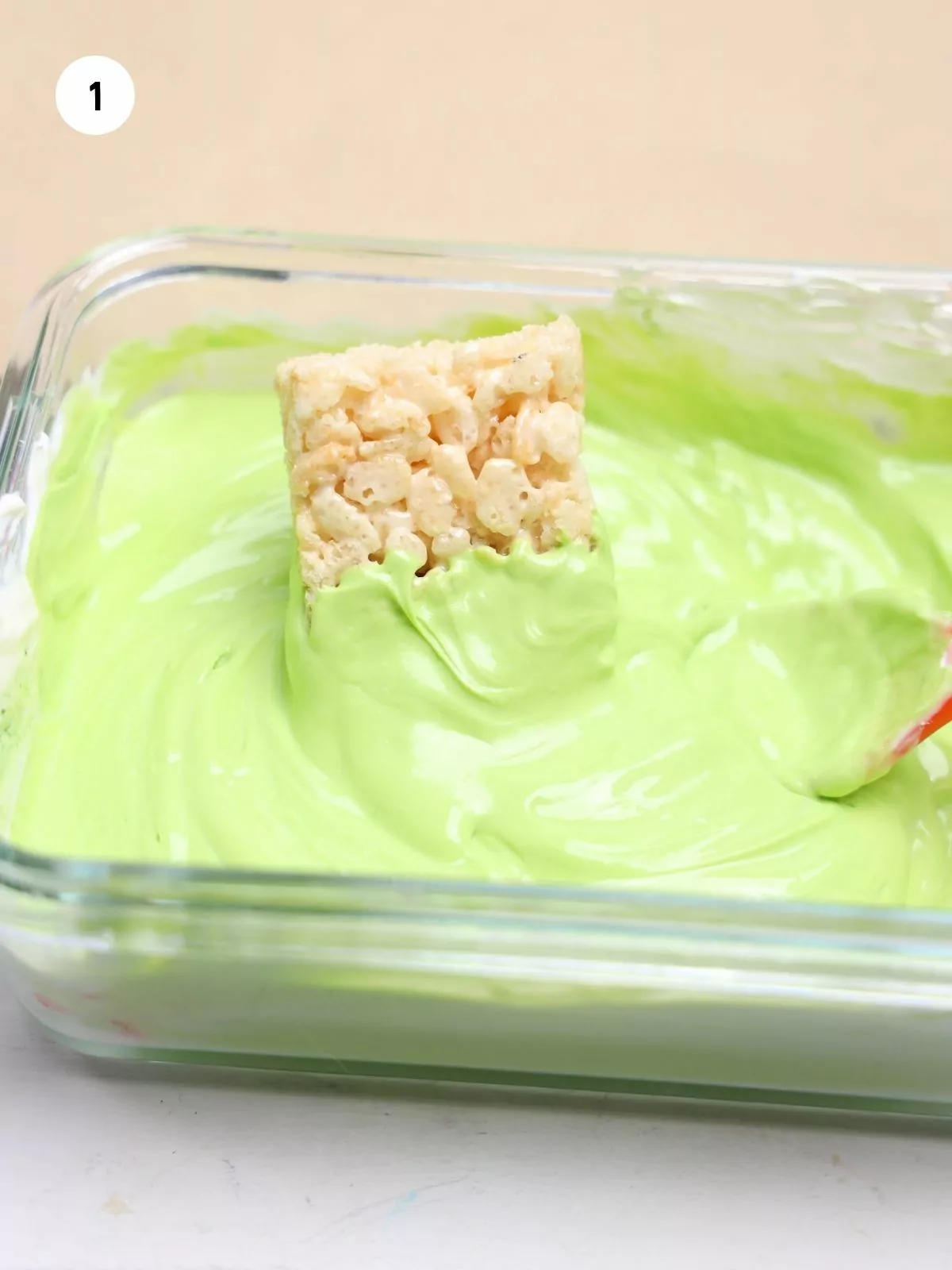 dip rice krispie treat in melted green white chocolate.