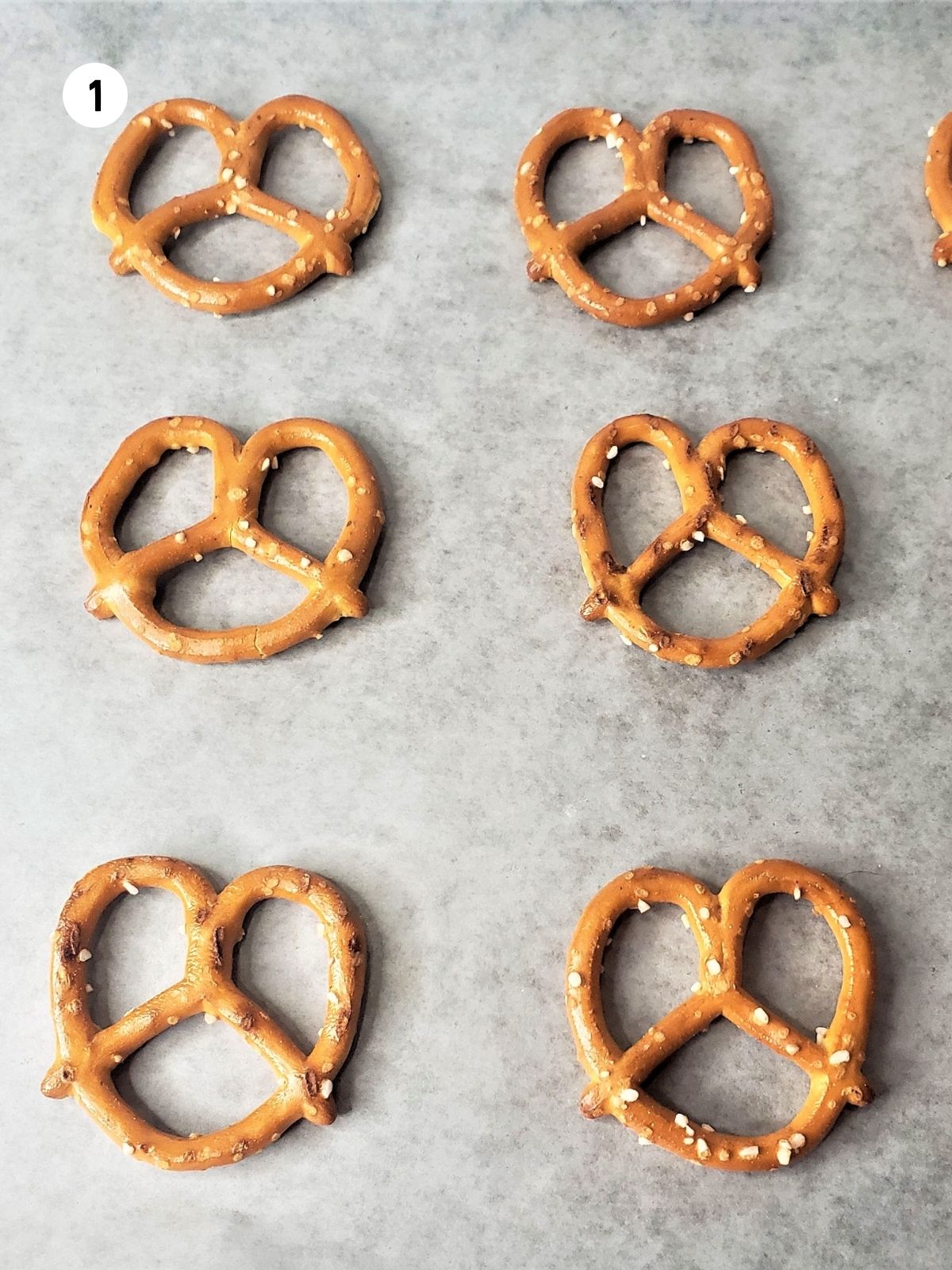 Prepare sheet pan with wax paper and pretzels.