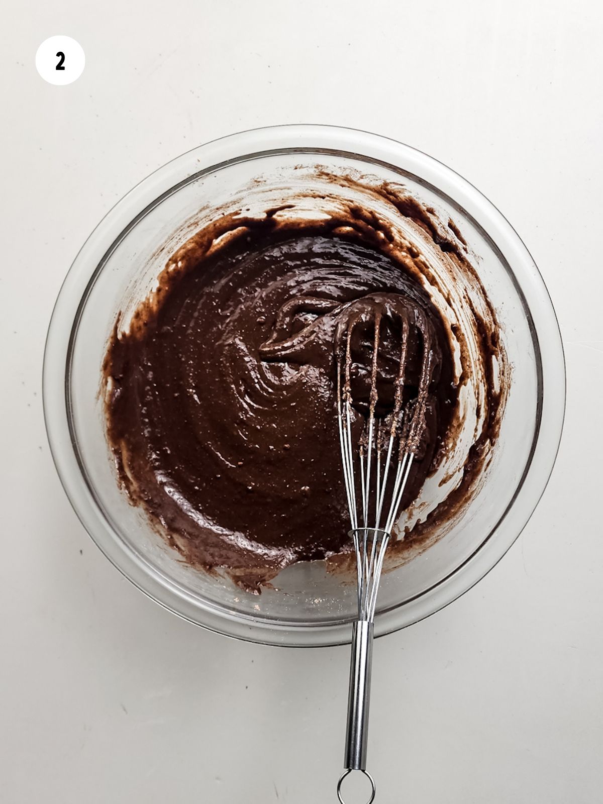 Brownie batter and whisk in mixing bowl.