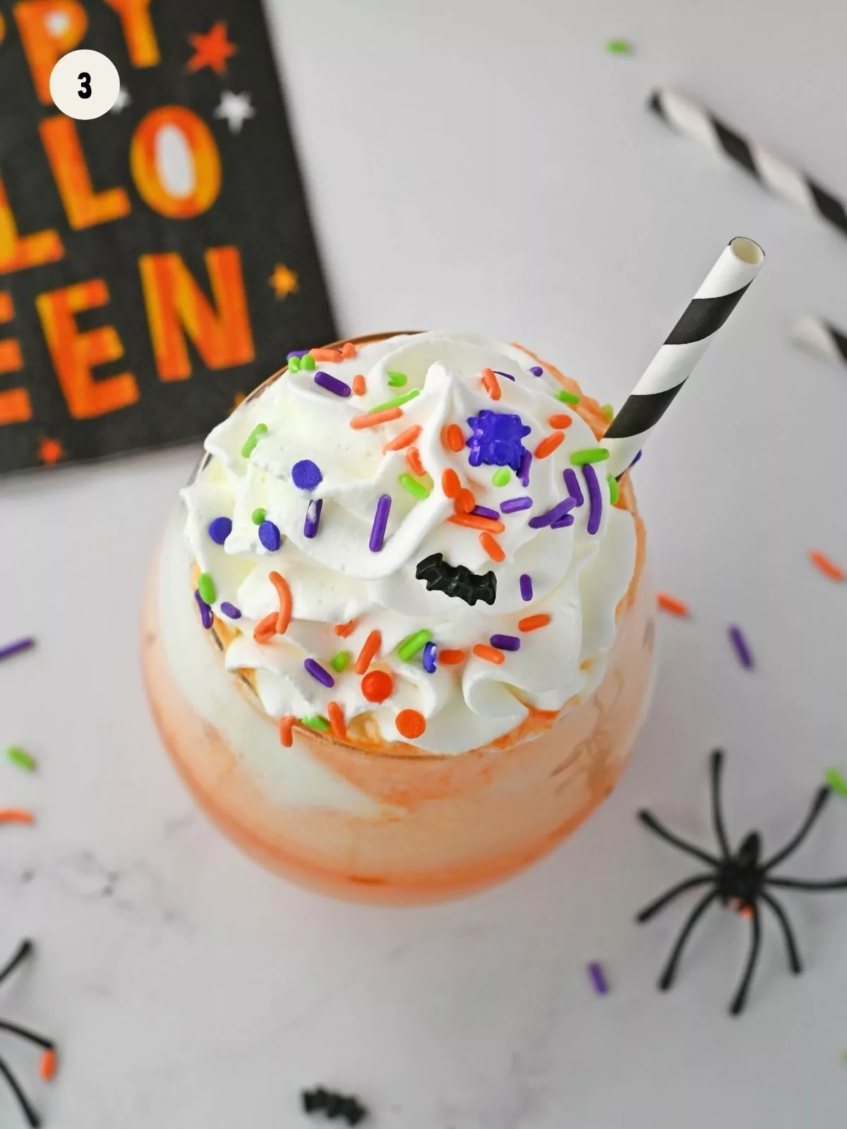 Top punch with whipped cream and sprinkles.