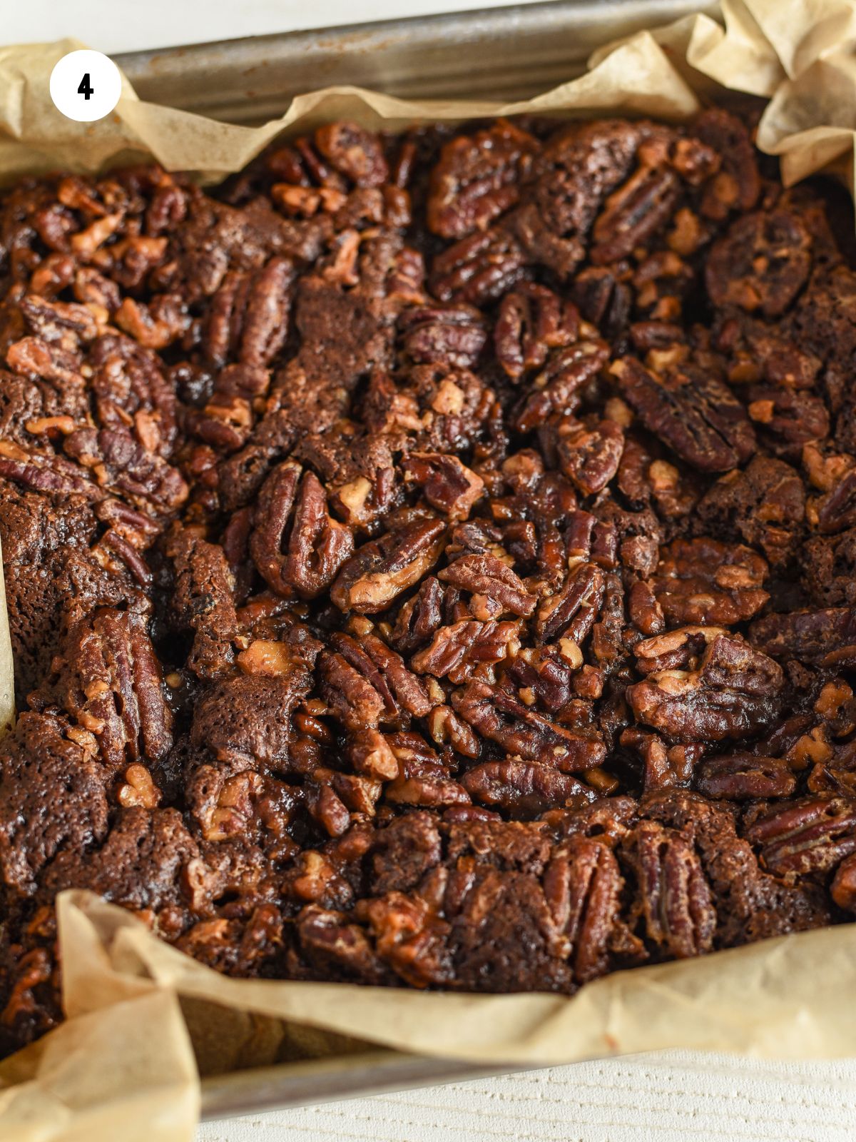 baked pecan pie brownies in a square pan.