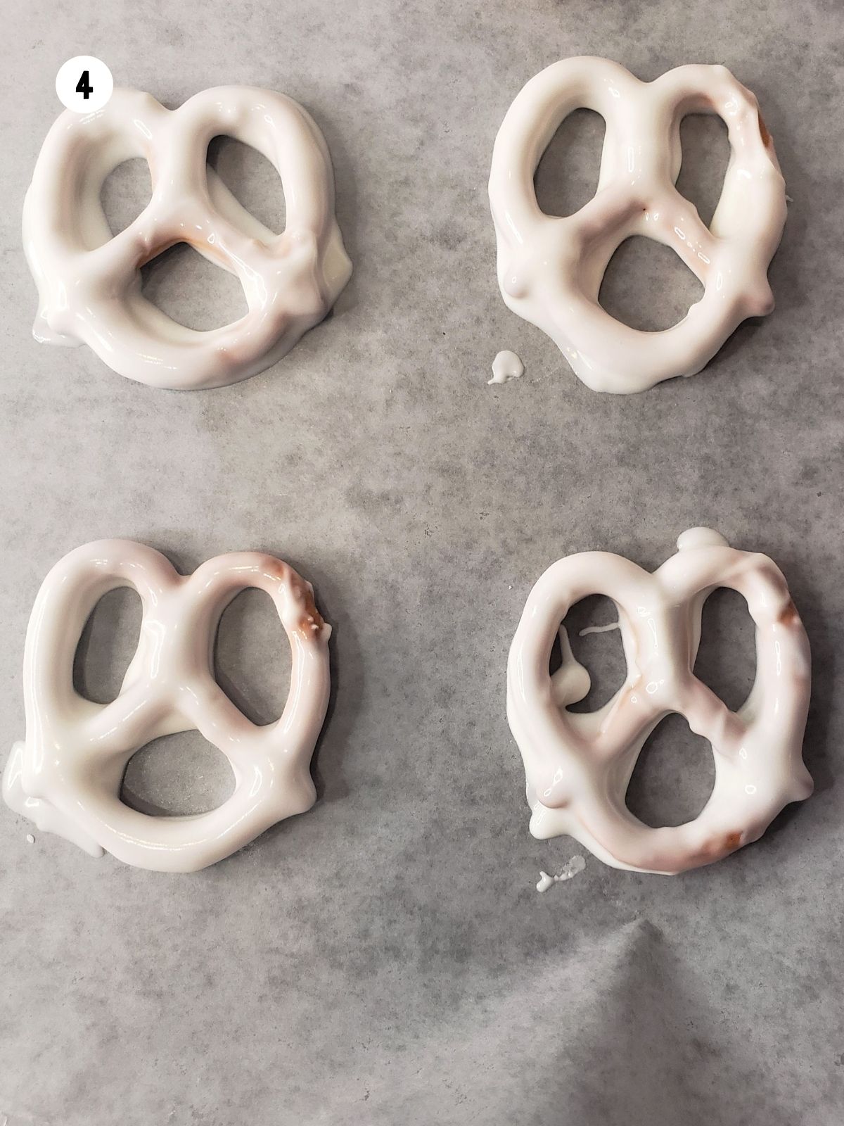 Chocolate Dipped Pretzels on wax paper.