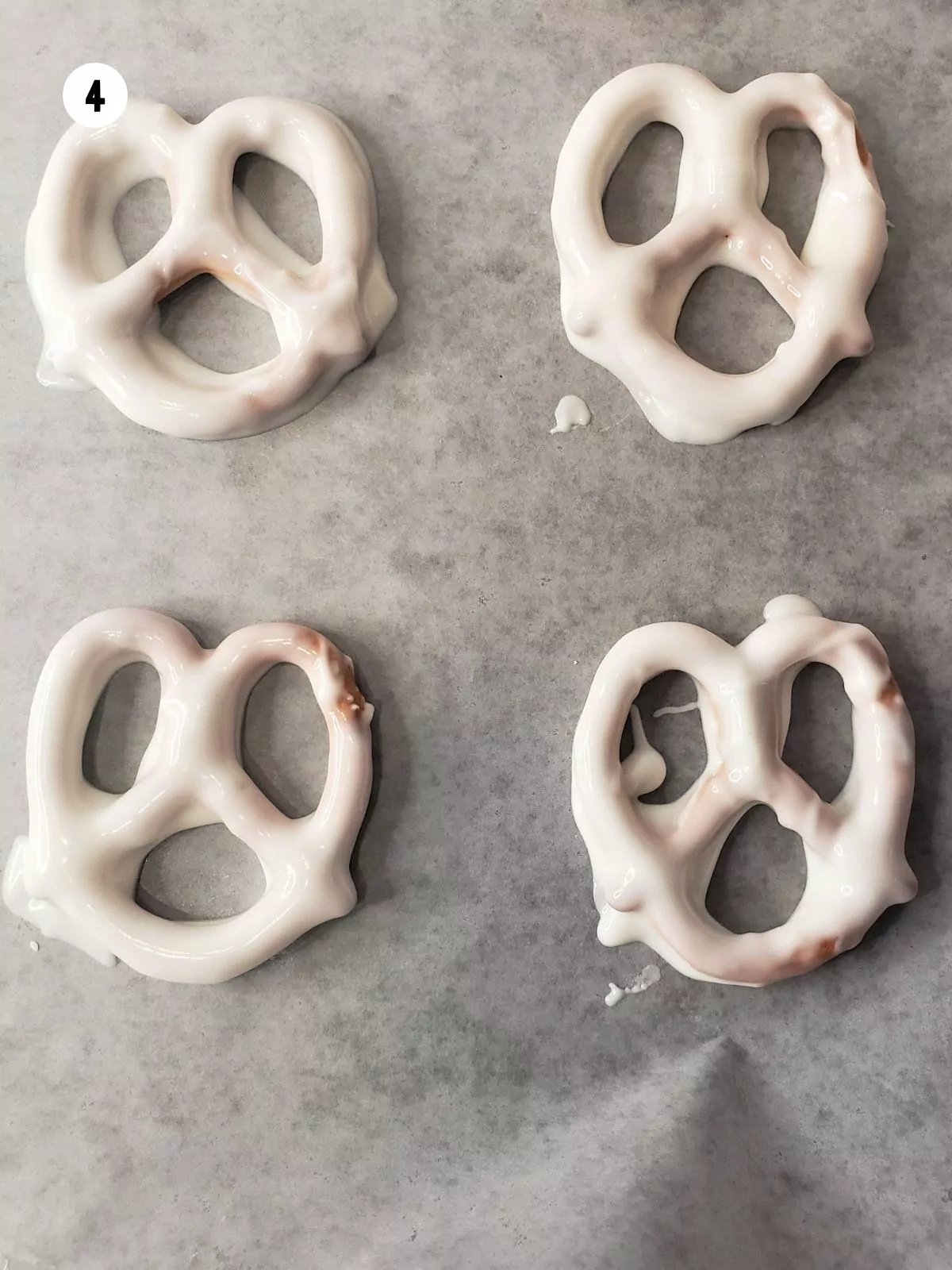 Chocolate Dipped Pretzels on wax paper.