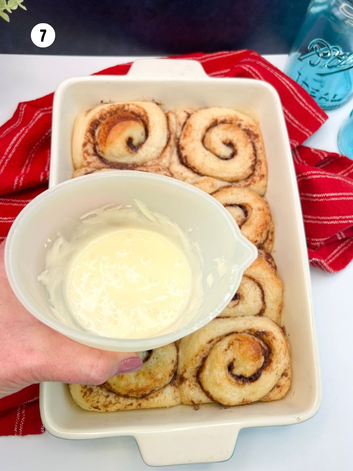 Cream cheese frosting in a small pitcher.