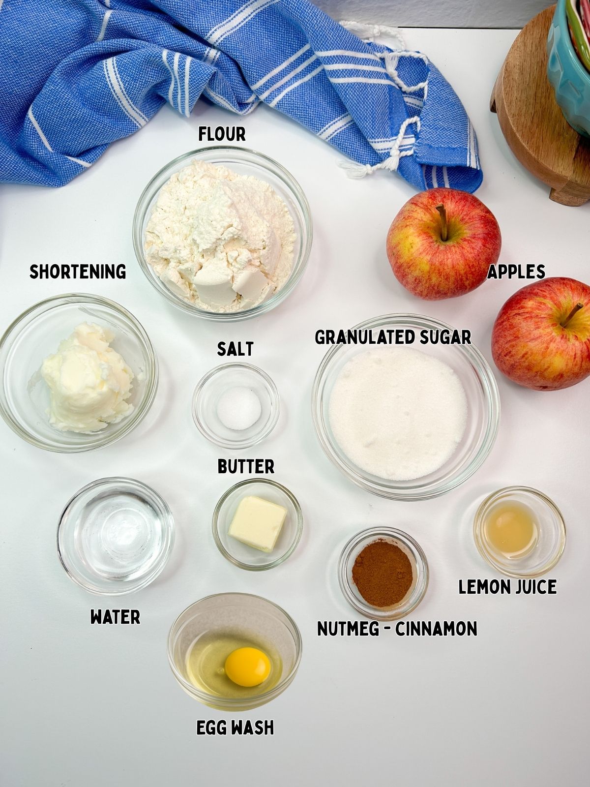 Ingredients for apple pie in bowls all labeled.