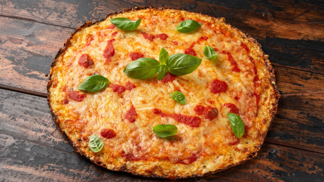 Cauliflower crust pizza with tomato sauce, cheese and basil. Healthy diet food