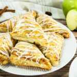 Apple Turnovers with glaze drizzled on top.